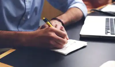 photo of student writing on paper